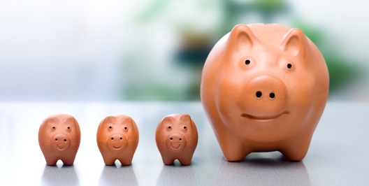 Conceptual view of compound interest - big piggy-bank and the small ones