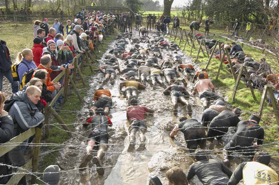 WOLVERHAMPTON, UNITED KINGDOM - JANUARY 27: Competitors tackle an obstacle course during the Tough Guy Challenge at South Perton Farm on January 27, 2008 near Wolverhampton, England.